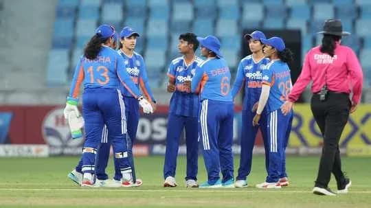 Indian women's cricket team discussing strategy on field Indian women's cricket team discussing strategy on field