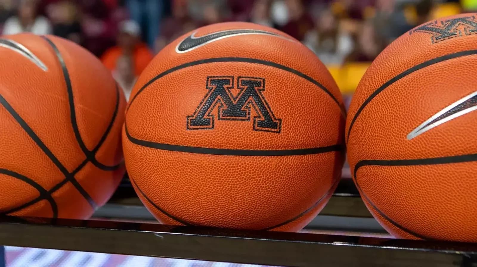 Three basketballs with Minnesota logo on display Three basketballs with Minnesota logo on display