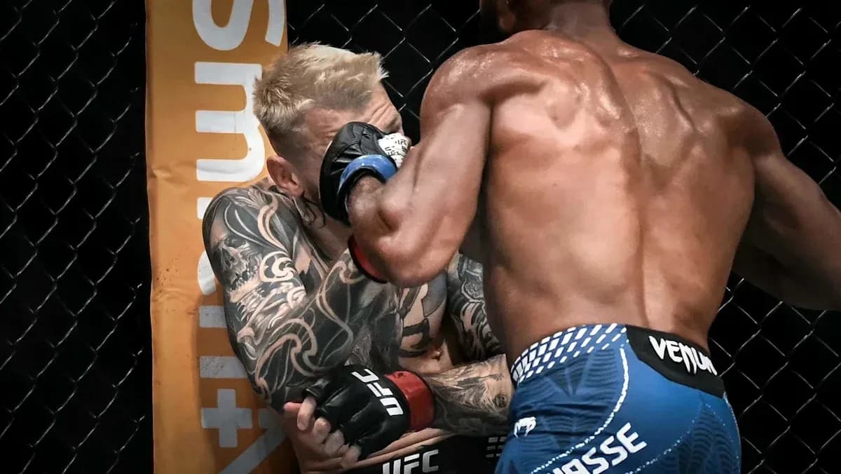 Two fighters engaged in a close exchange during match Two fighters engaged in a close exchange during match