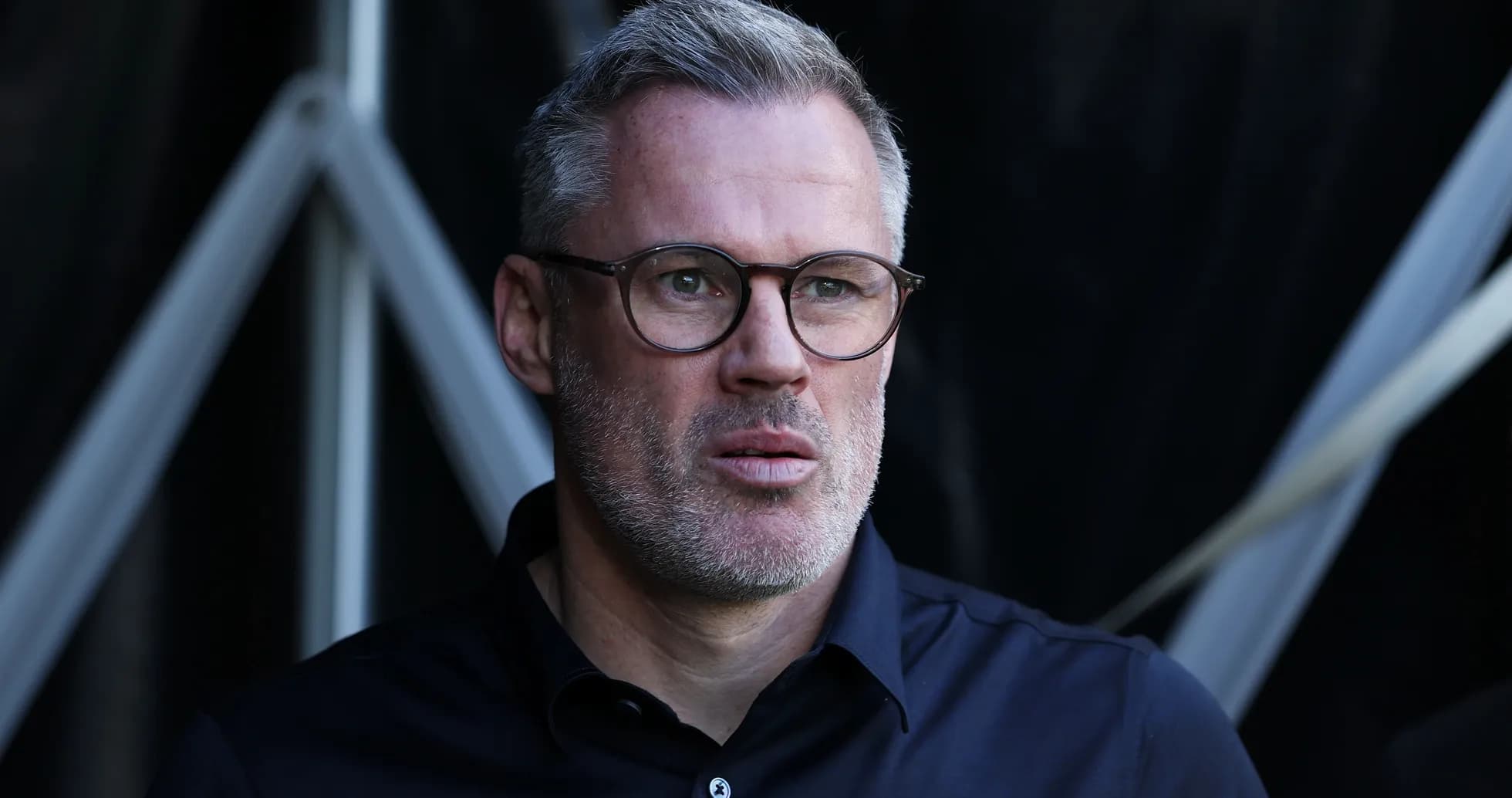 Man with glasses looking intently during event Man with glasses looking intently during event