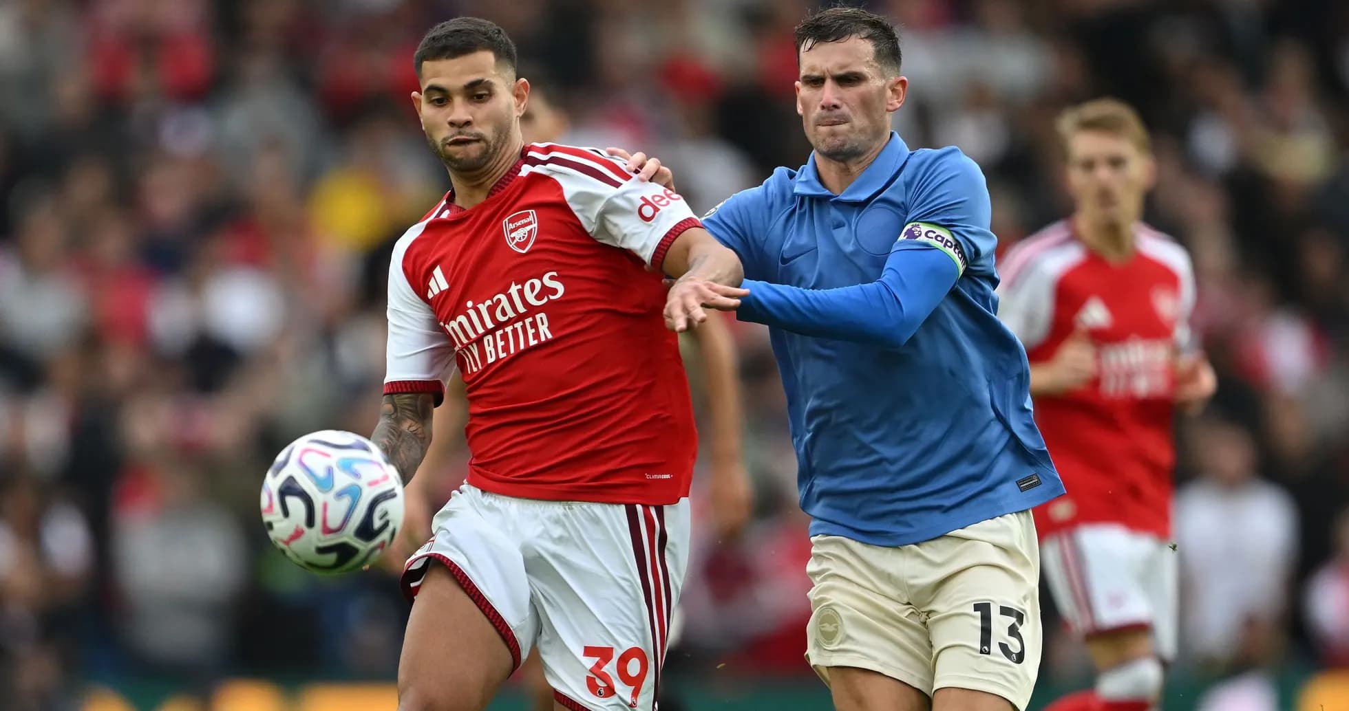 Player in red jersey evading opponent in blue jersey Player in red jersey evading opponent in blue jersey