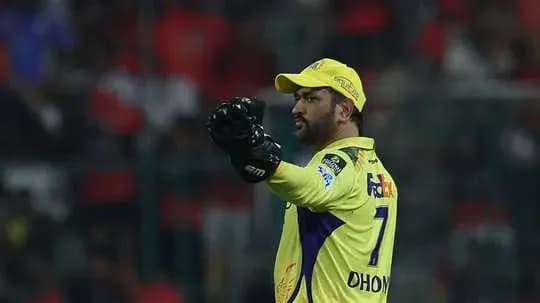 Cricketer in yellow jersey signaling during match Cricketer in yellow jersey signaling during match