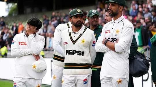 Pakistani cricketers in team attire during match Pakistani cricketers in team attire during match