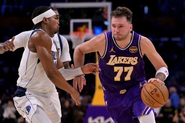 Player dribbling basketball while being defended Player dribbling basketball while being defended