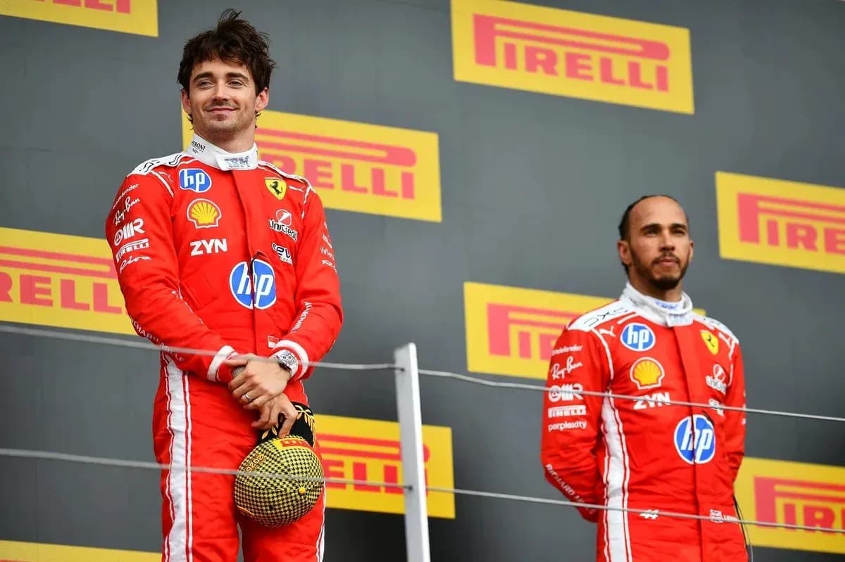 Two Formula 1 drivers on podium celebrating victory Two Formula 1 drivers on podium celebrating victory