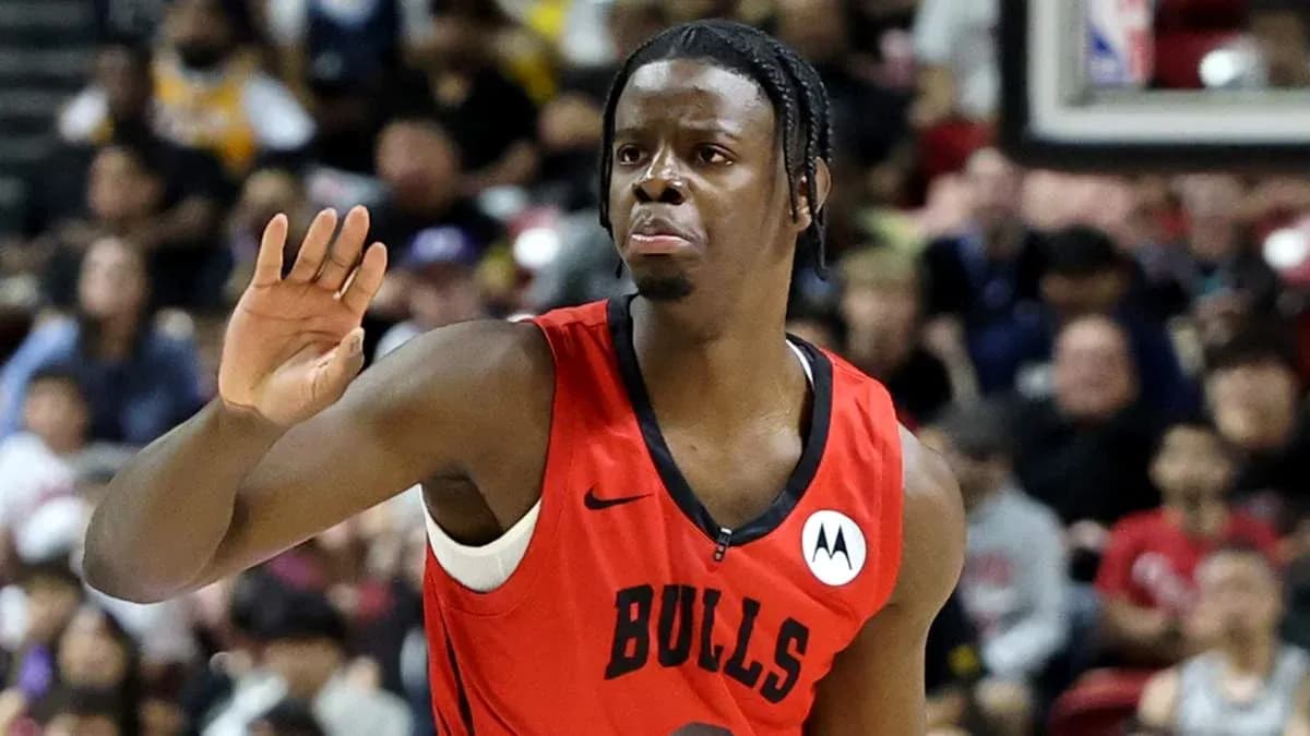 Player gesturing during basketball game in red jersey Player gesturing during basketball game in red jersey
