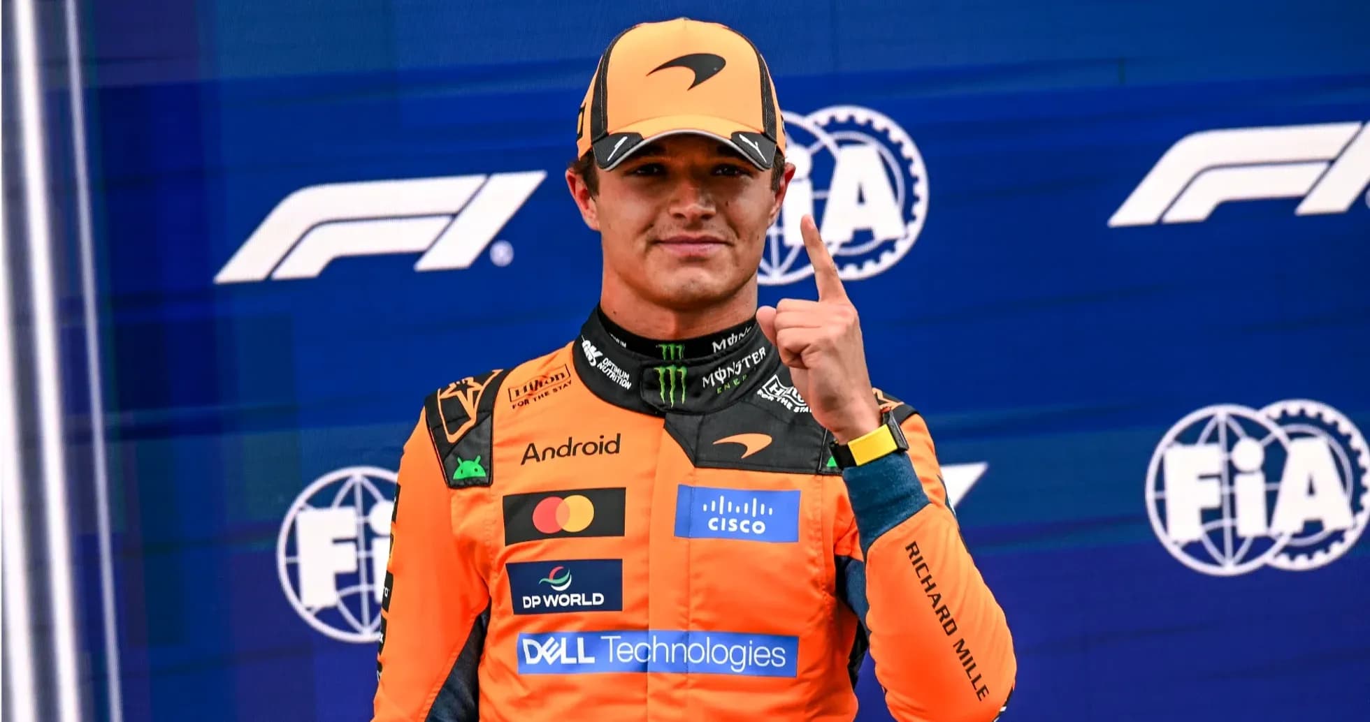 Driver celebrating with finger raised on podium Driver celebrating with finger raised on podium