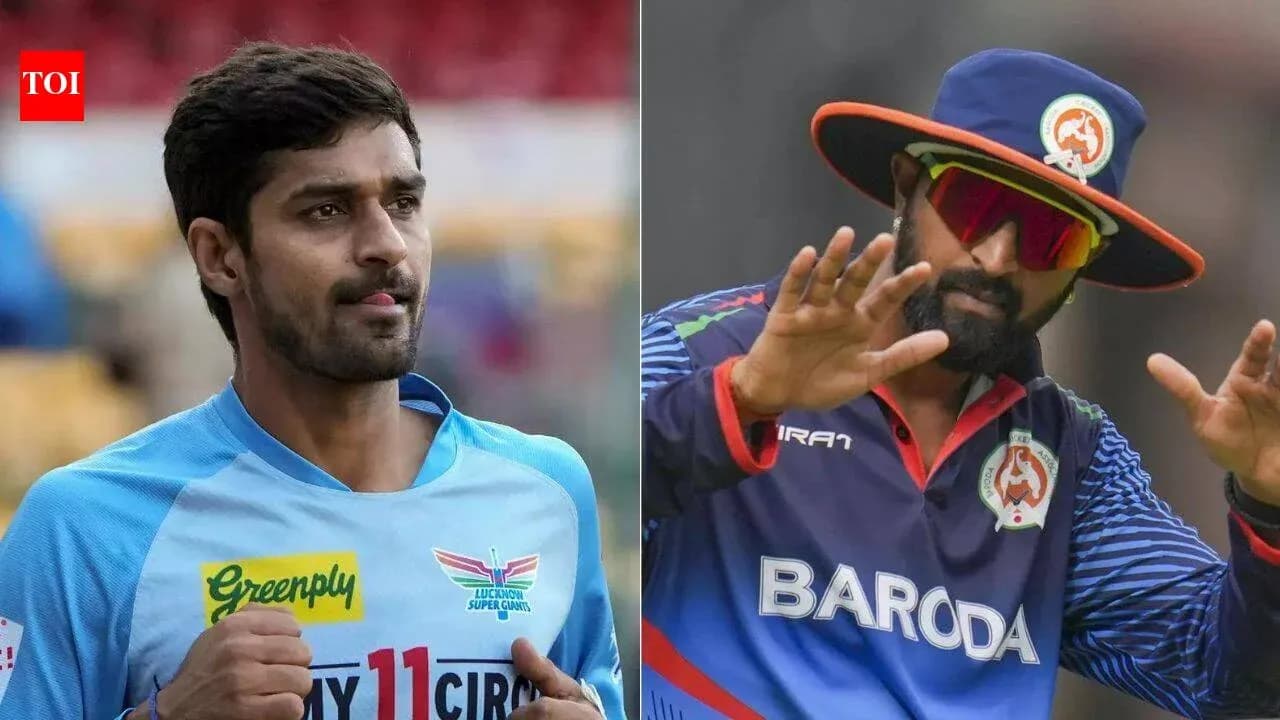 Two cricketers in team jerseys during a match Two cricketers in team jerseys during a match