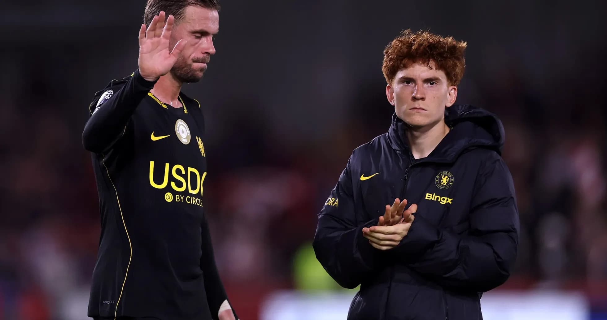 Two players acknowledging fans after the match Two players acknowledging fans after the match