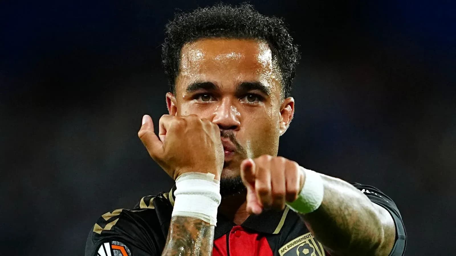 Player celebrating with clenched fists after a goal Player celebrating with clenched fists after a goal
