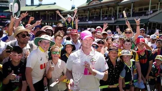 Cricketer celebrating with fans after victory Cricketer celebrating with fans after victory