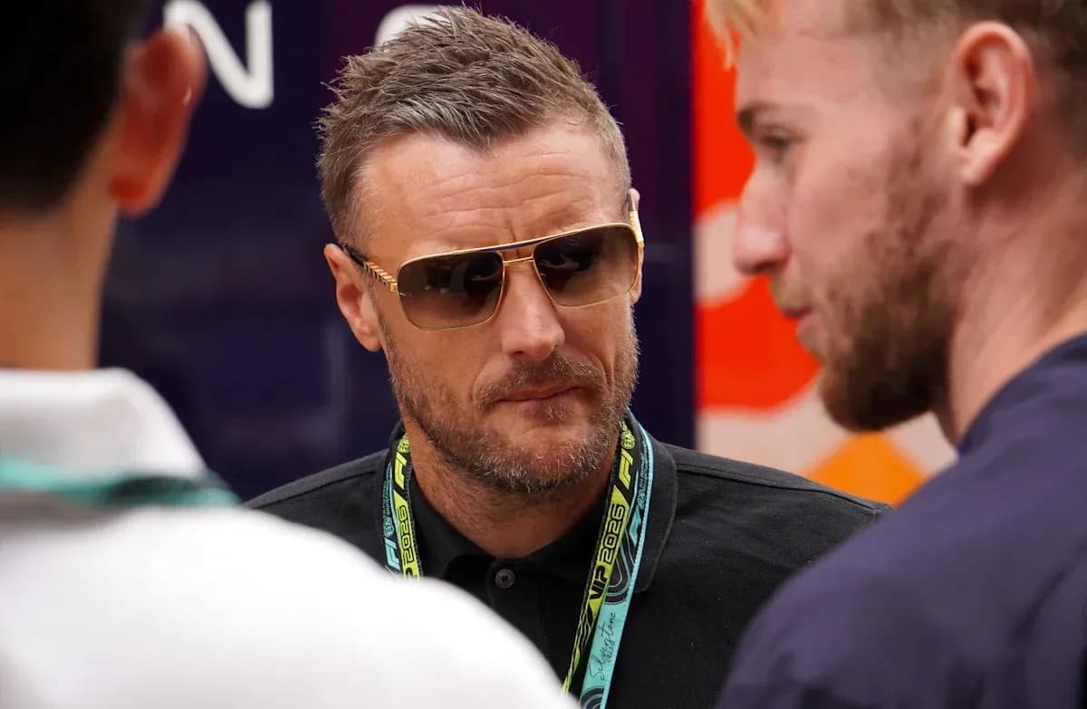 Man wearing sunglasses speaking with two others Man wearing sunglasses speaking with two others
