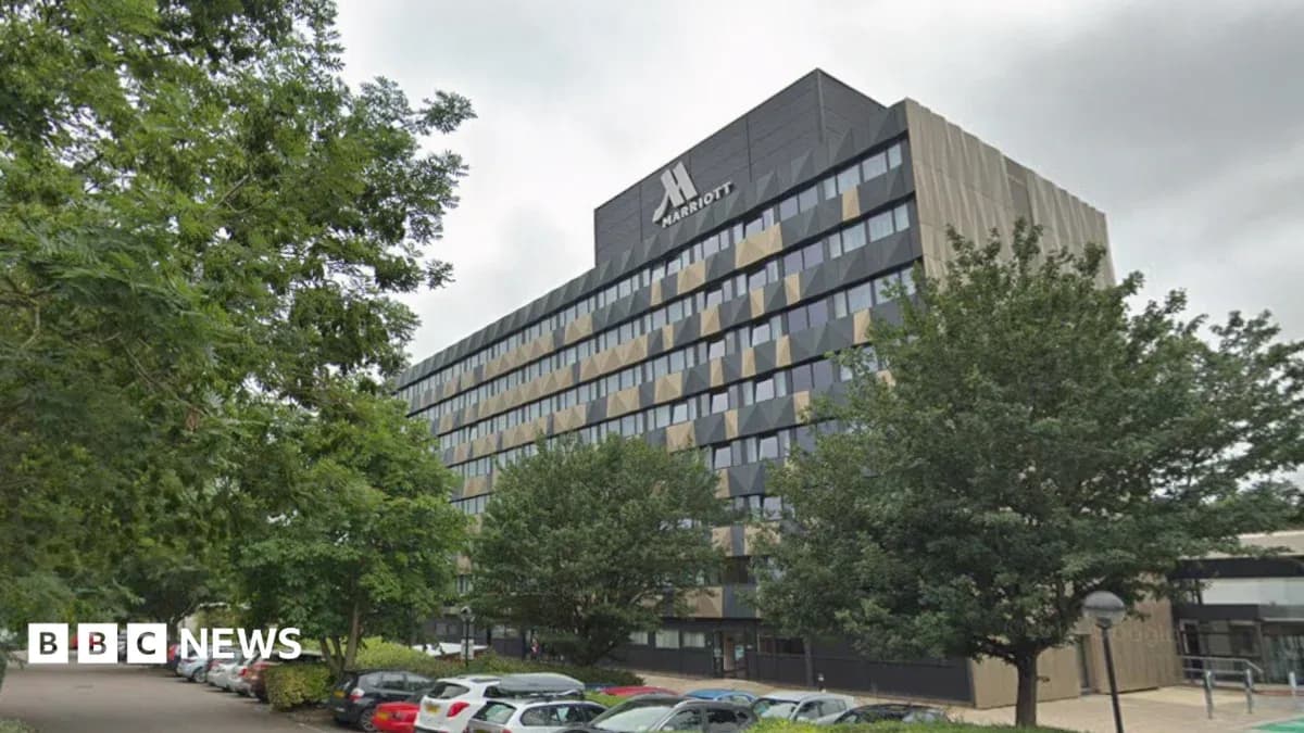Marriott hotel building with trees and parking area Marriott hotel building with trees and parking area