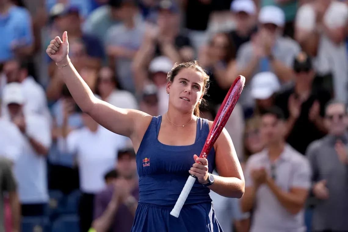 Player celebrating with raised hand and racket Player celebrating with raised hand and racket