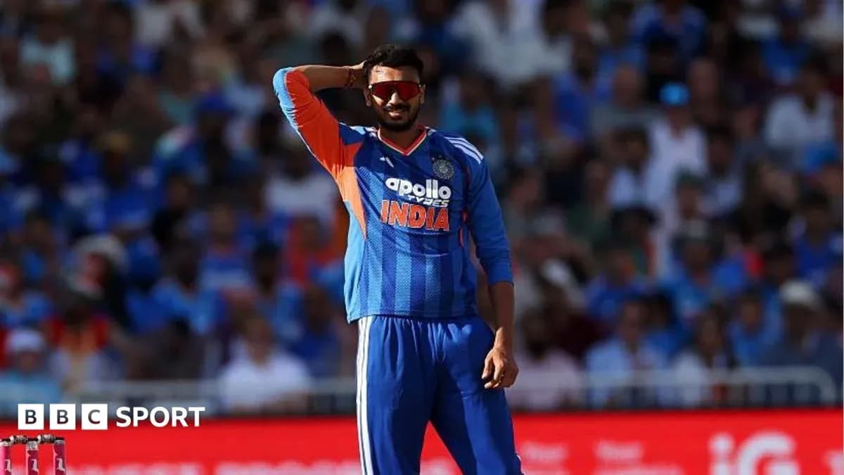 Cricketer in India jersey signaling during match Cricketer in India jersey signaling during match