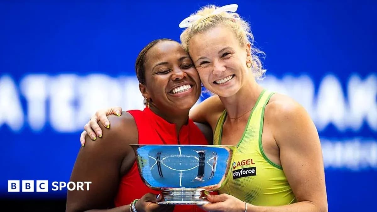 Two tennis players celebrating with a trophy Two tennis players celebrating with a trophy