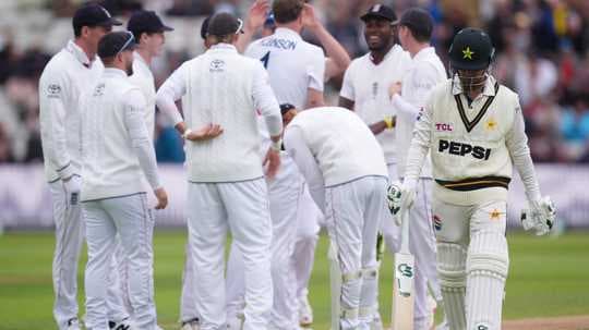 Pakistani player walking past celebrating English team Pakistani player walking past celebrating English team
