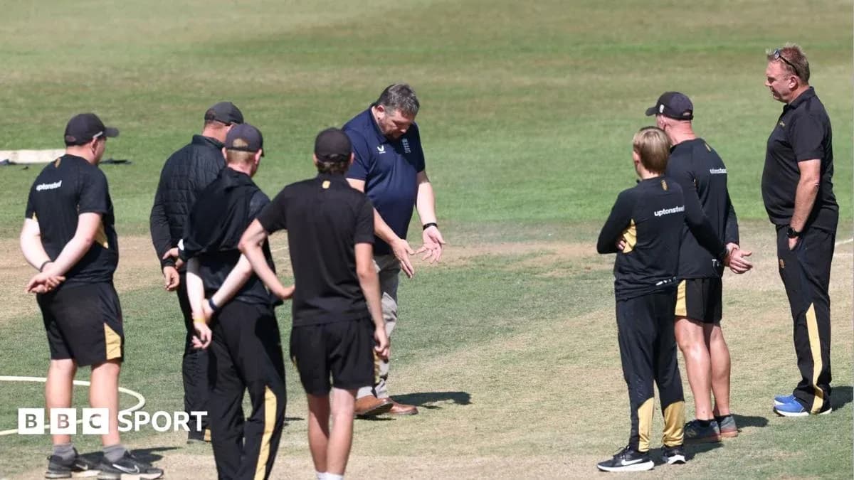 Coaches discussing strategy during cricket training session Coaches discussing strategy during cricket training session