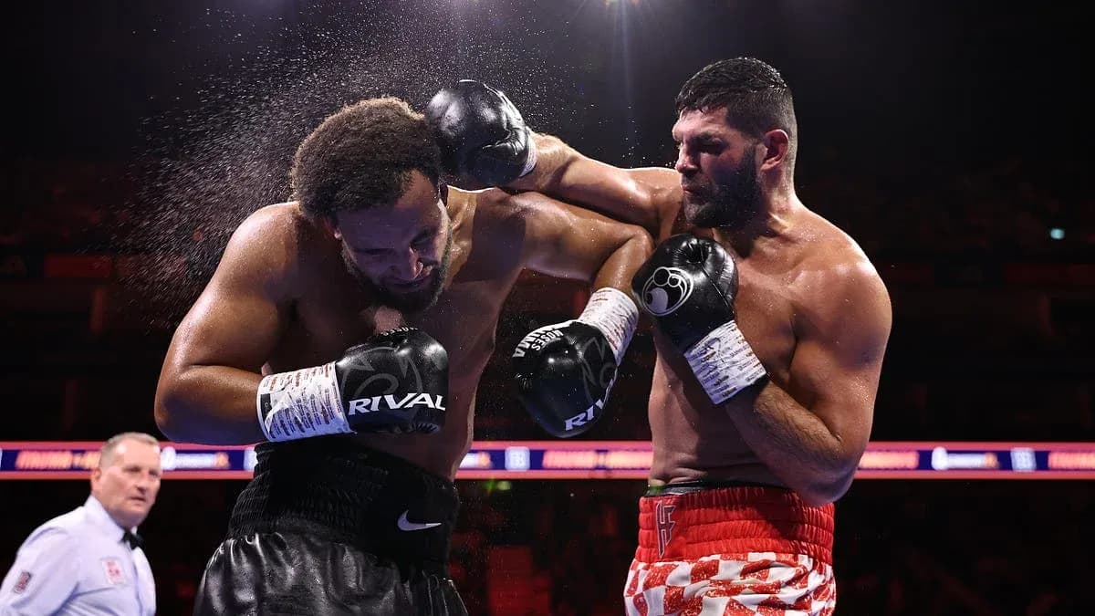 Two boxers exchanging punches in the ring Two boxers exchanging punches in the ring