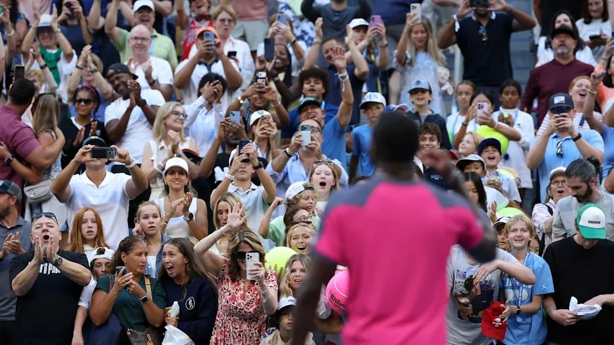 Crowd cheering with phones raised at event Crowd cheering with phones raised at event