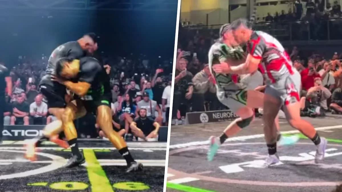 Two wrestlers competing in a match with crowd watching Two wrestlers competing in a match with crowd watching