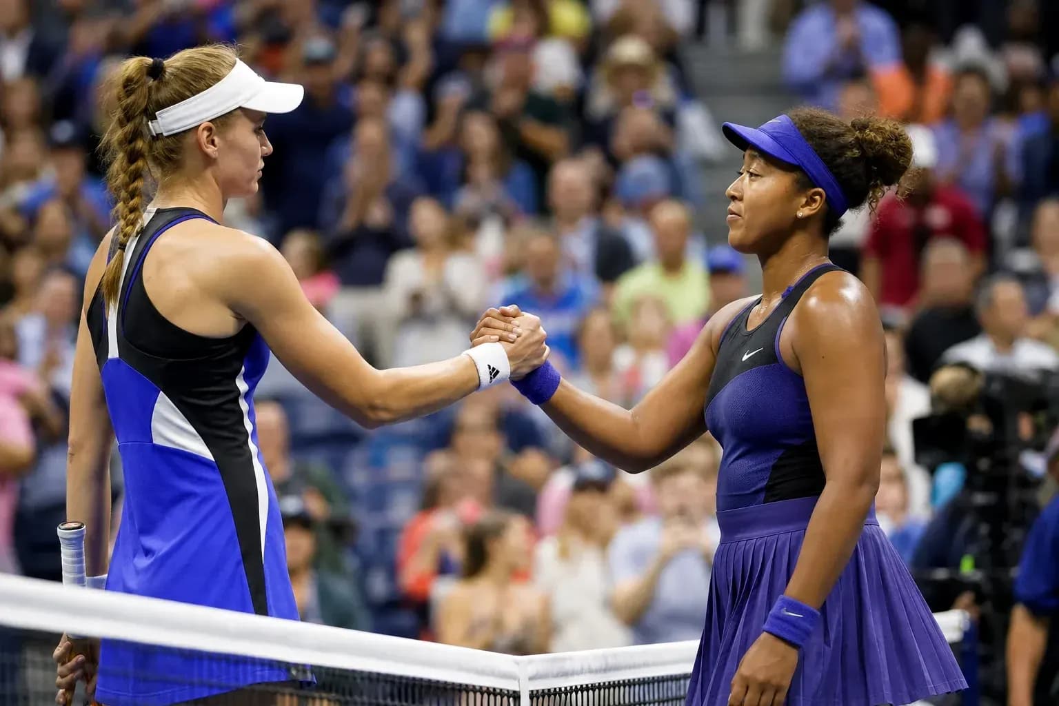 Players shaking hands after a tennis match Players shaking hands after a tennis match