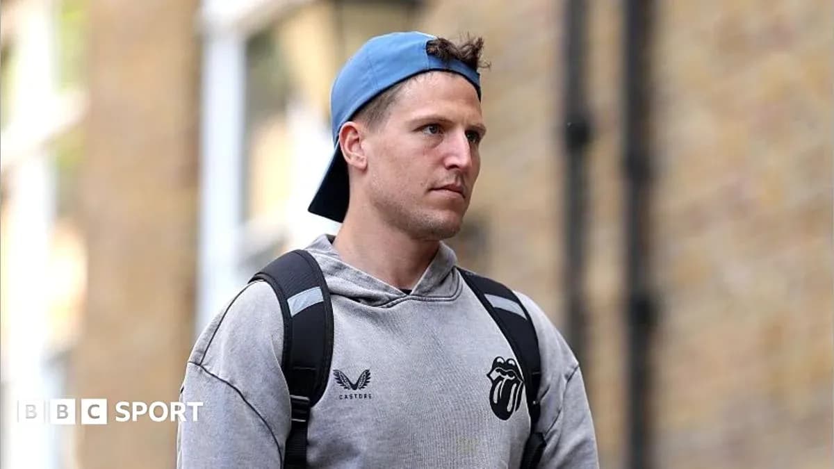 Man wearing a cap and hoodie walking outdoors Man wearing a cap and hoodie walking outdoors