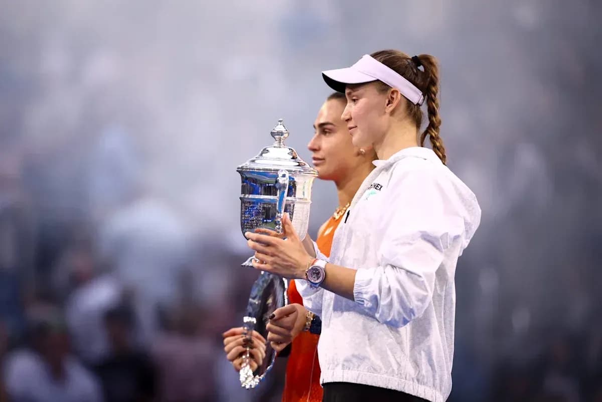 Two tennis players holding trophies after match Two tennis players holding trophies after match