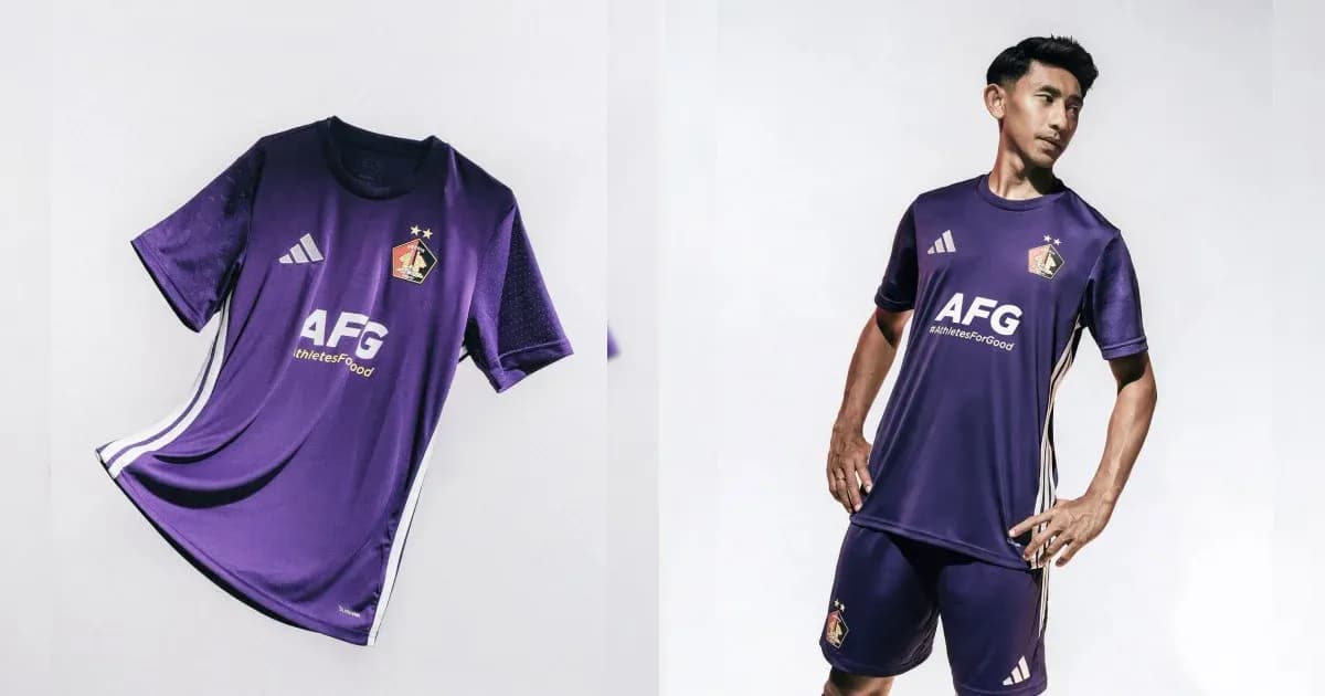 Purple football kit displayed with player wearing it Purple football kit displayed with player wearing it