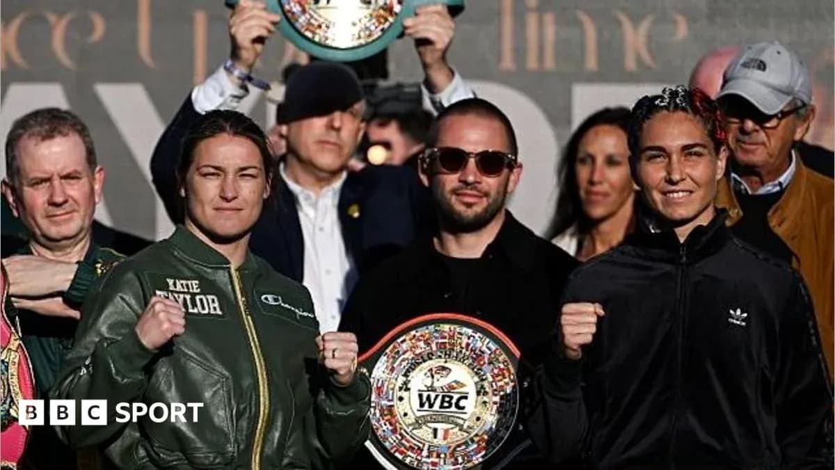 Katie Taylor and opponent posing with championship belts Katie Taylor and opponent posing with championship belts