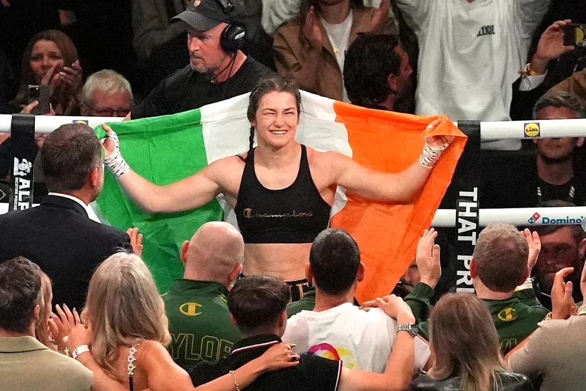 Female boxer celebrating with Irish flag after victory Female boxer celebrating with Irish flag after victory