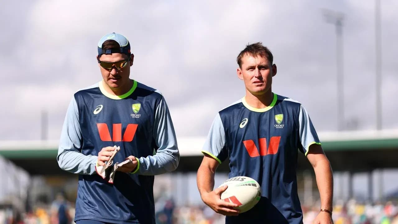 Two cricketers walking during training session Two cricketers walking during training session