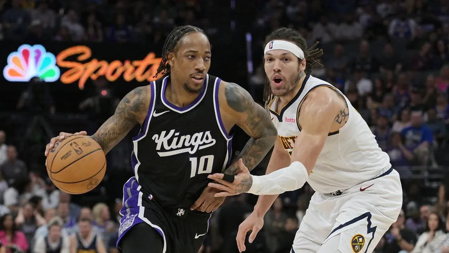 Player dribbling basketball while being closely defended Player dribbling basketball while being closely defended