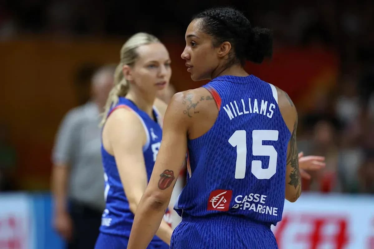 Two basketball players in team jerseys on court Two basketball players in team jerseys on court