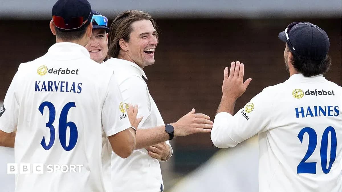Cricketers celebrating a wicket on the field Cricketers celebrating a wicket on the field