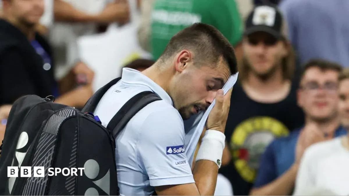 Player wiping face with towel during match Player wiping face with towel during match