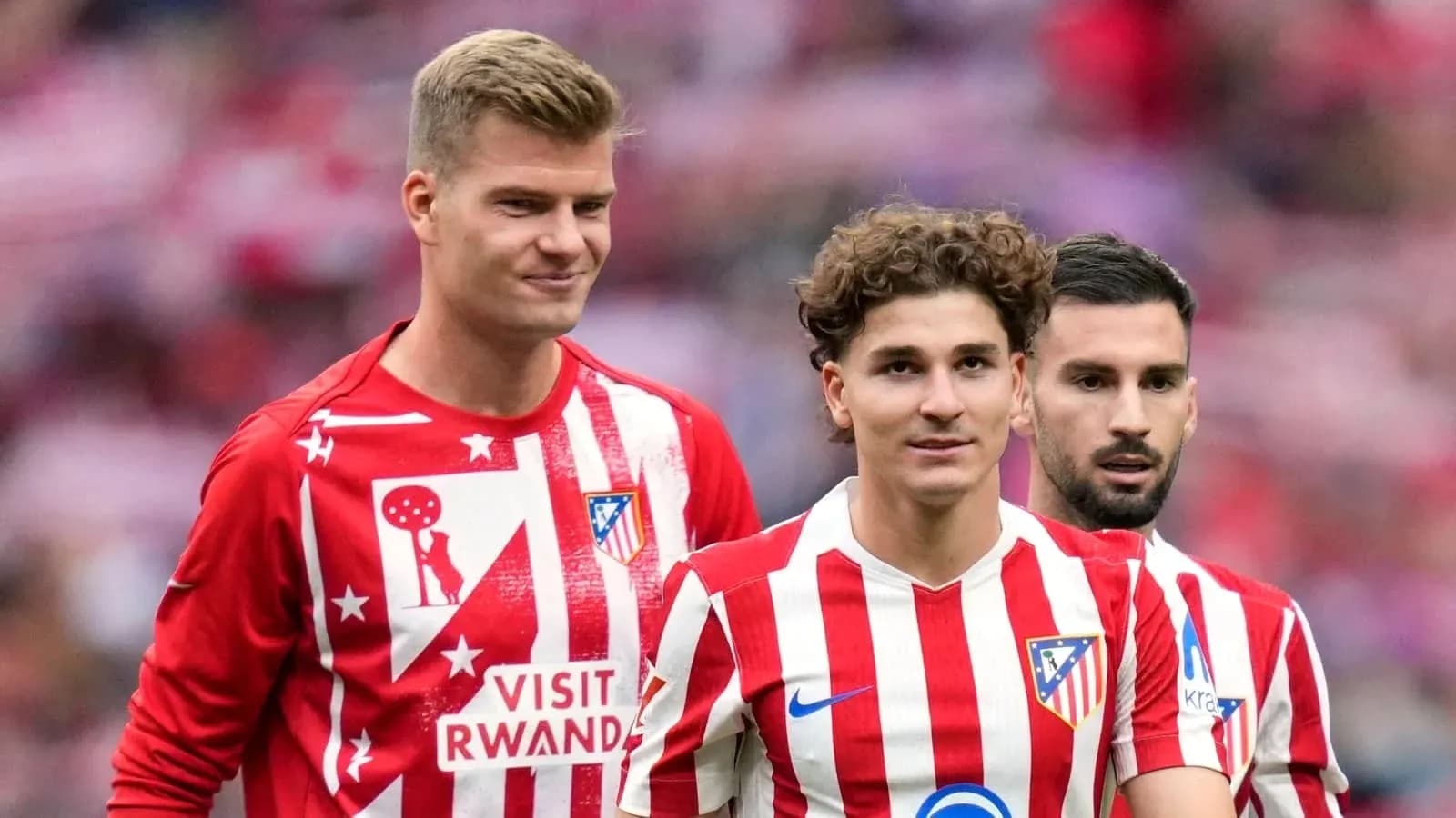 Atletico Madrid players in warm-up jerseys on pitch Atletico Madrid players in warm-up jerseys on pitch