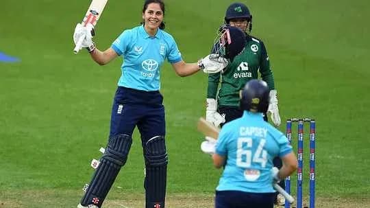 Batswoman celebrating a boundary during cricket match Batswoman celebrating a boundary during cricket match