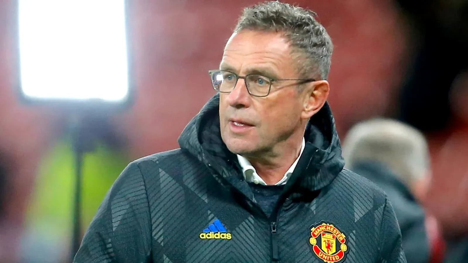 Coach wearing Manchester United jacket during match Coach wearing Manchester United jacket during match