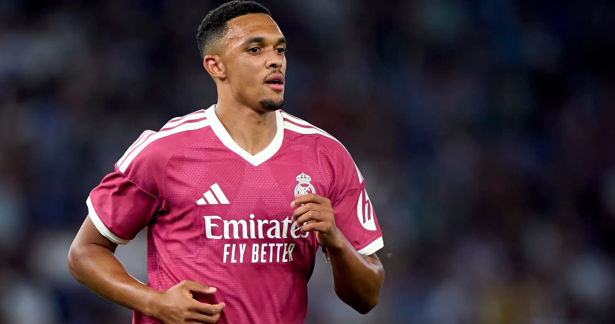 Player running in pink Real Madrid jersey Player running in pink Real Madrid jersey