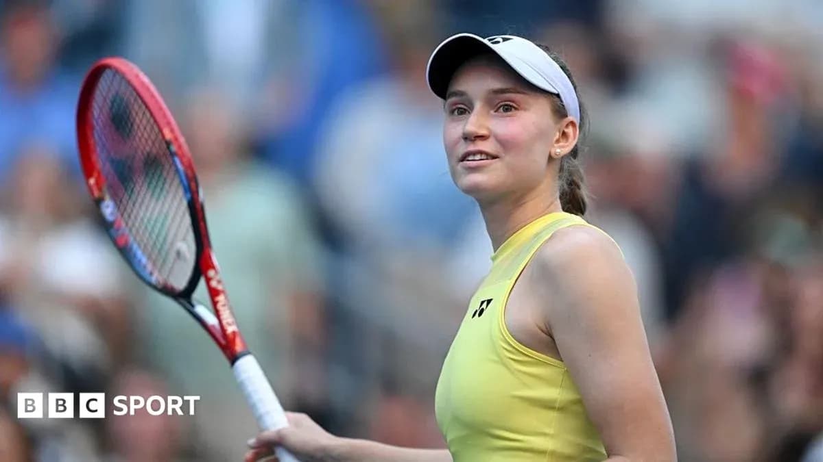 Tennis player smiling while holding a racket Tennis player smiling while holding a racket