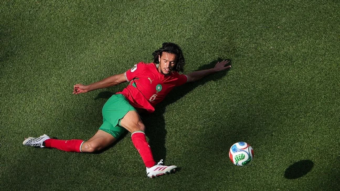 Player in red and green uniform on the ground Player in red and green uniform on the ground