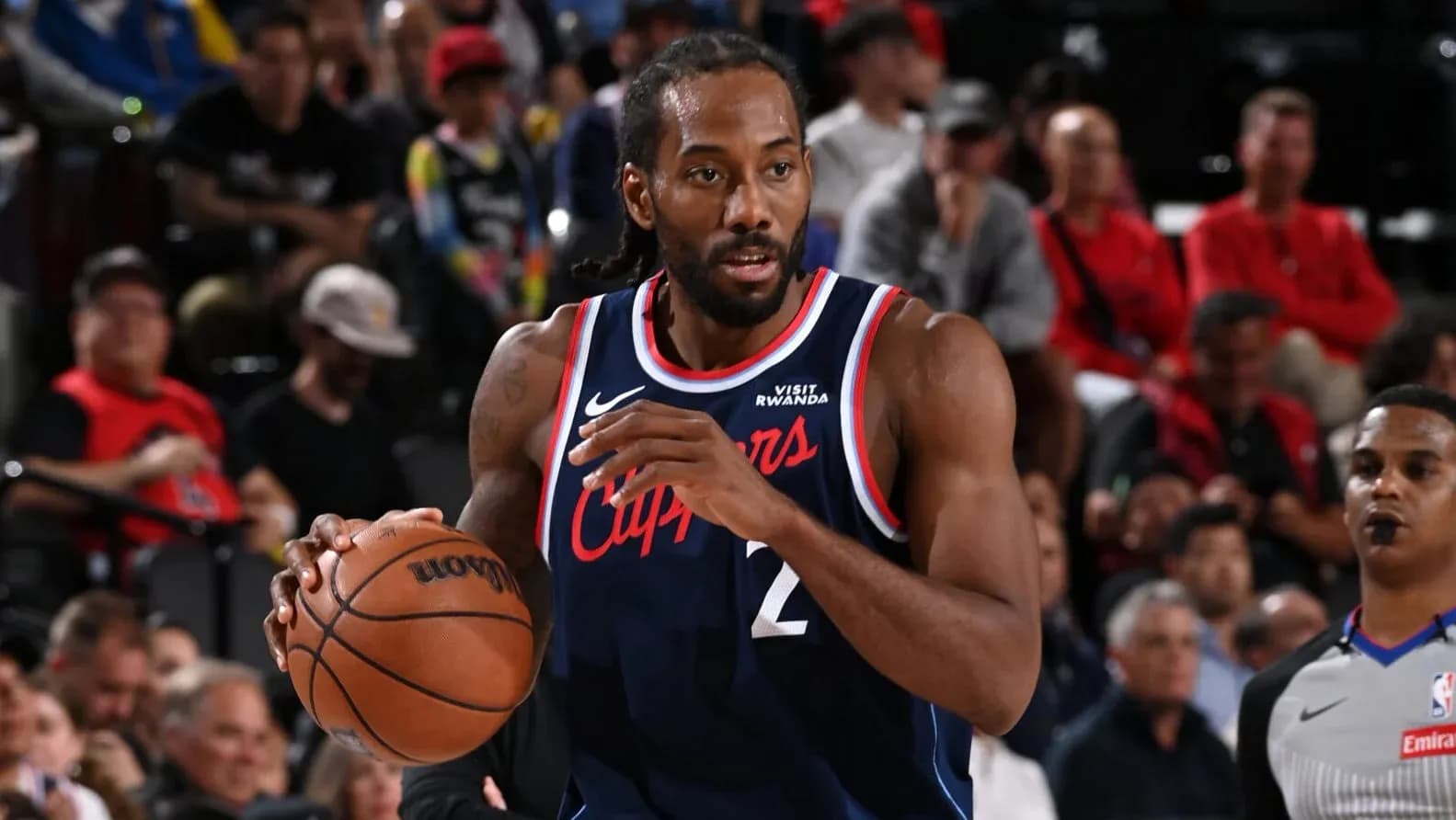 Player dribbling basketball during a game Player dribbling basketball during a game