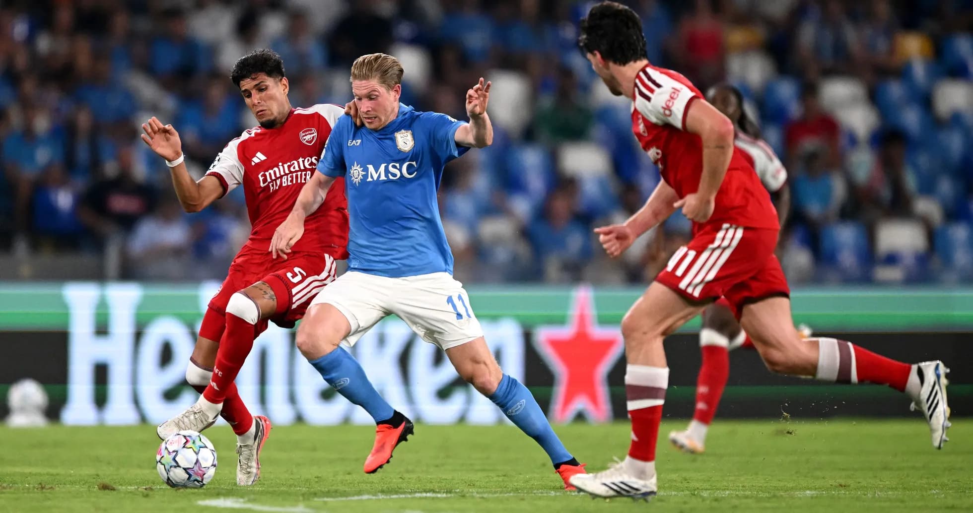 Players contesting possession during a football match Players contesting possession during a football match