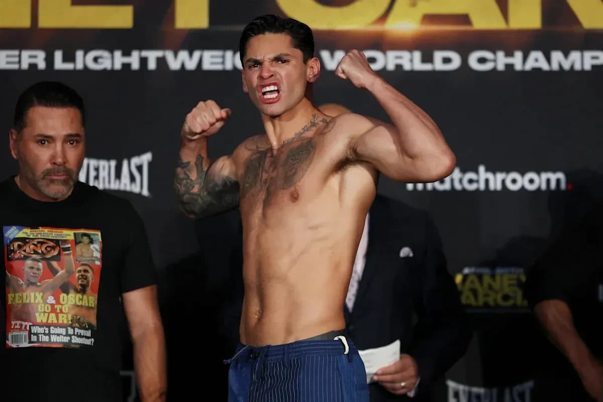 Fighter posing at weigh-in event with trainer nearby Fighter posing at weigh-in event with trainer nearby