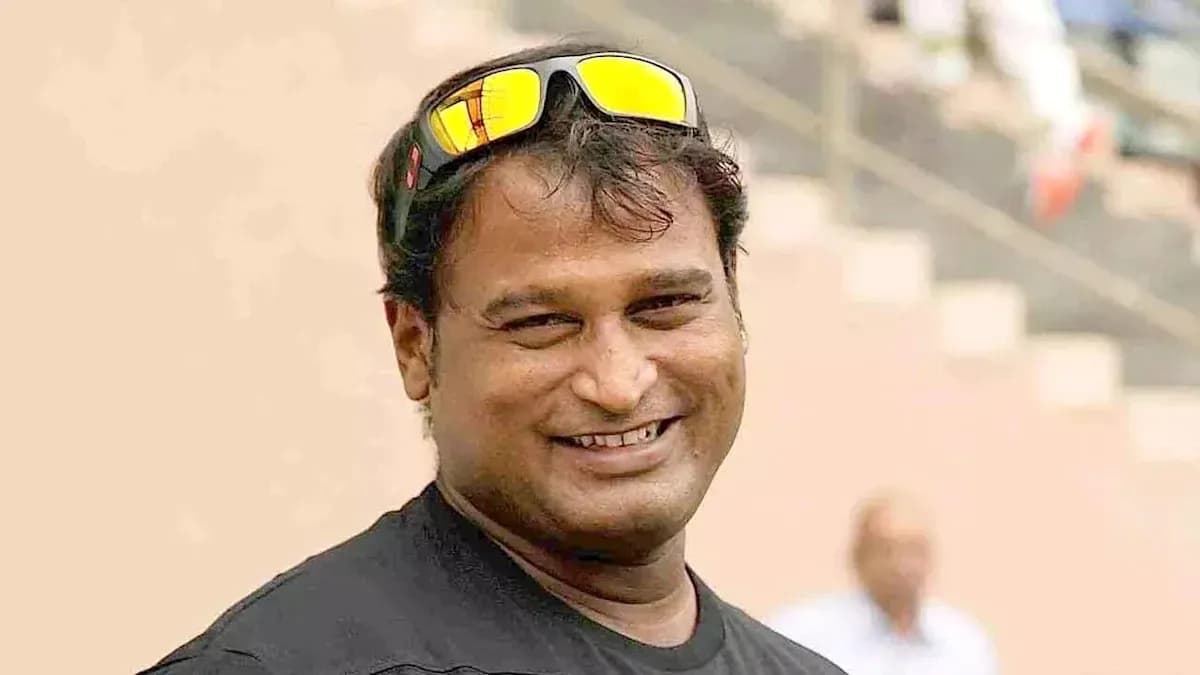 Smiling man wearing sunglasses at a sports venue Smiling man wearing sunglasses at a sports venue