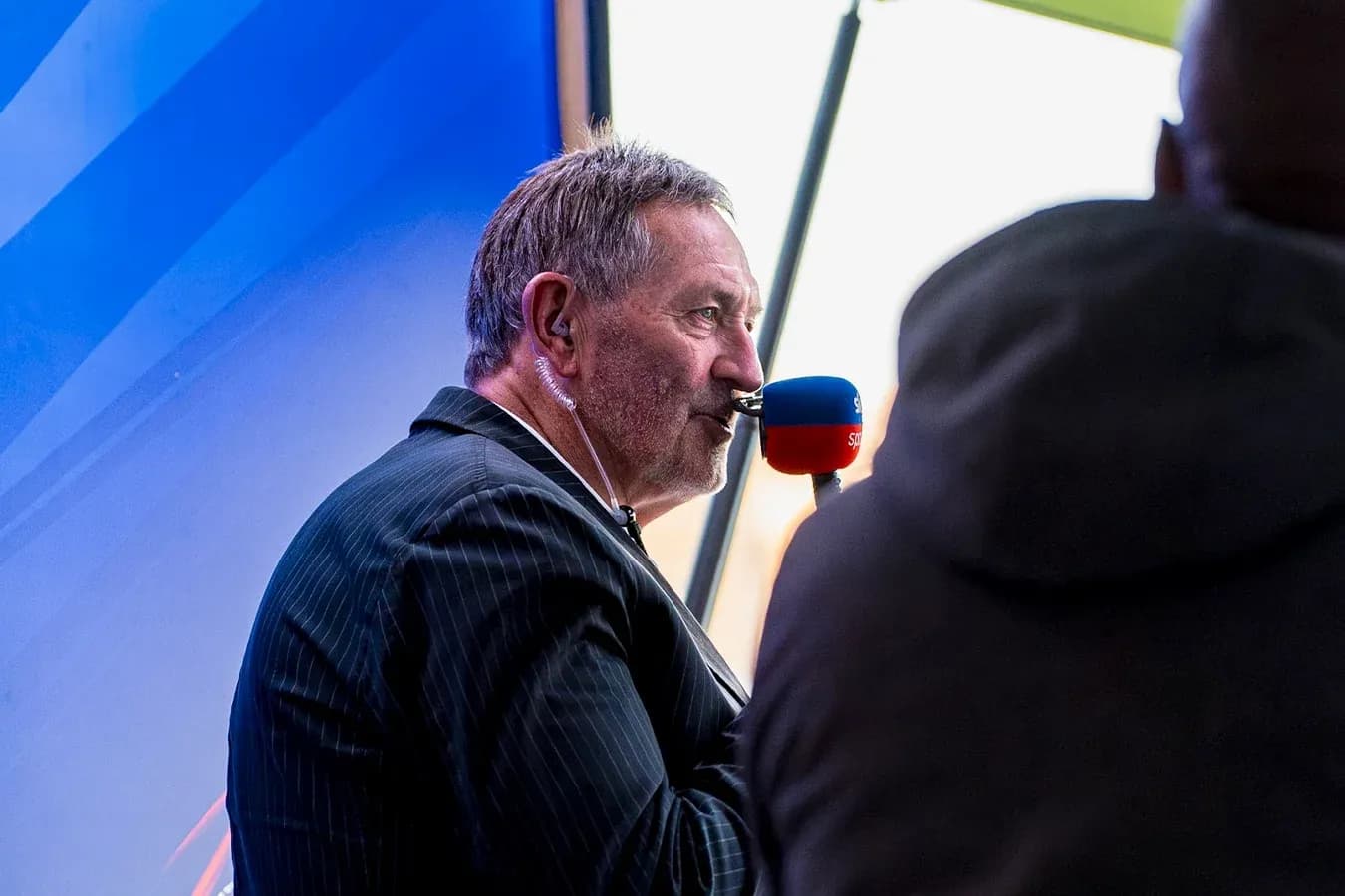 Sportscaster speaking into microphone during broadcast Sportscaster speaking into microphone during broadcast