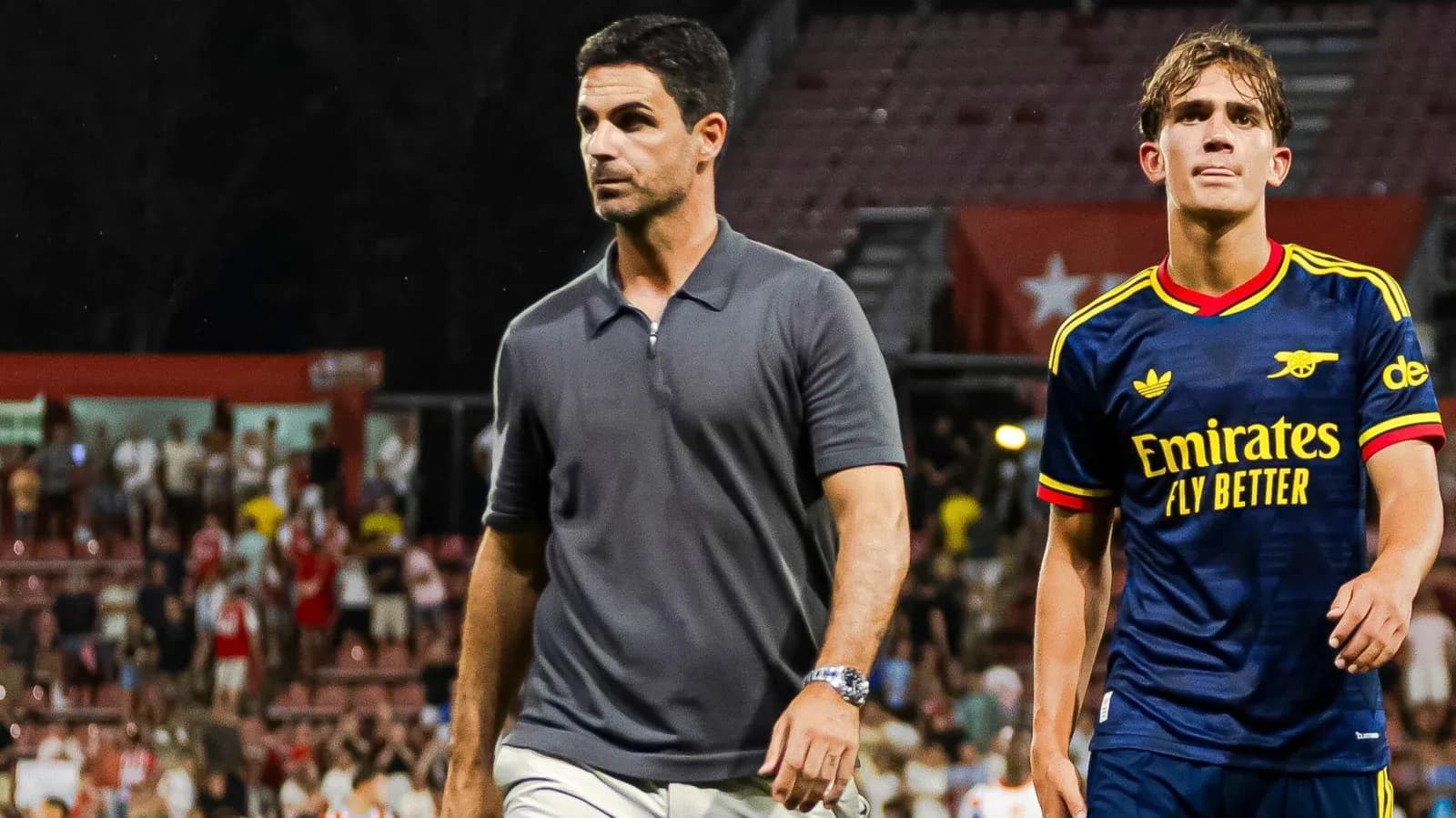 Coach and player walking off the field after match Coach and player walking off the field after match