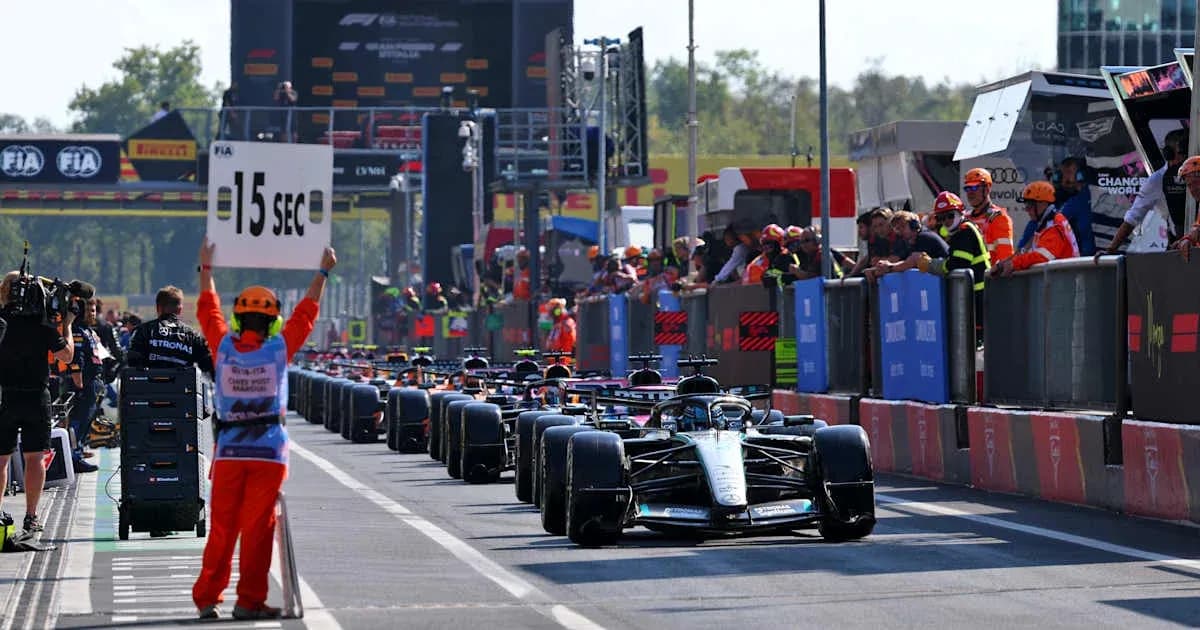 Cars in pit lane with 15-second penalty sign Cars in pit lane with 15-second penalty sign