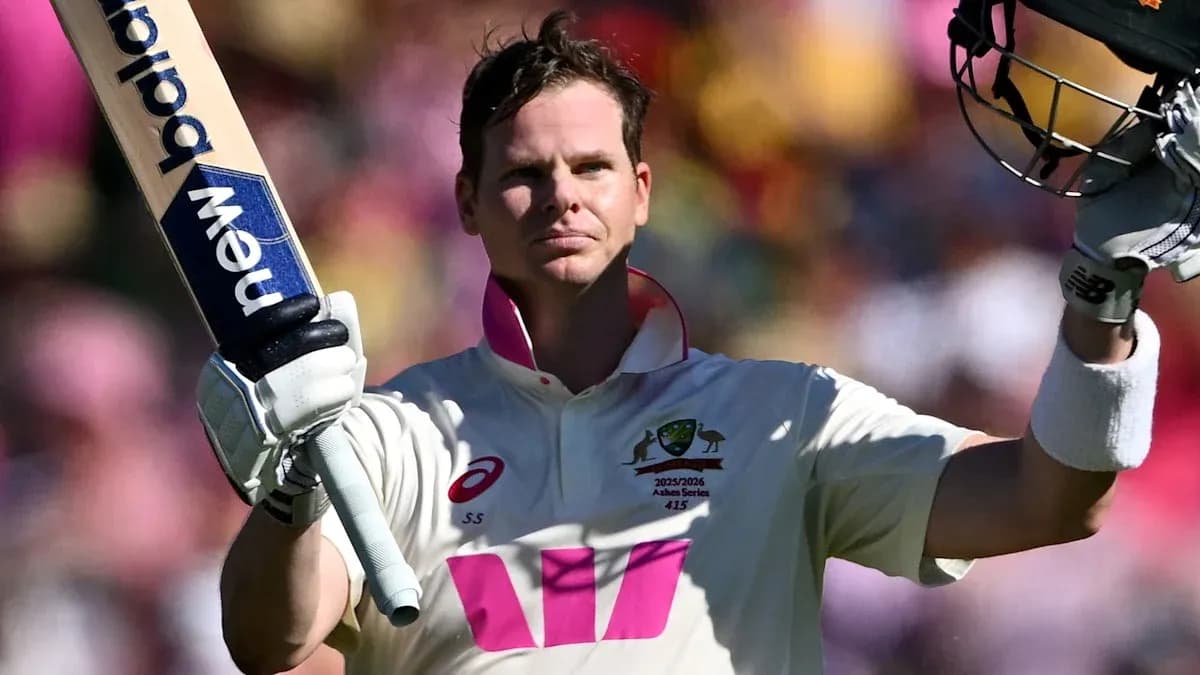 Cricketer celebrating century with raised bat Cricketer celebrating century with raised bat